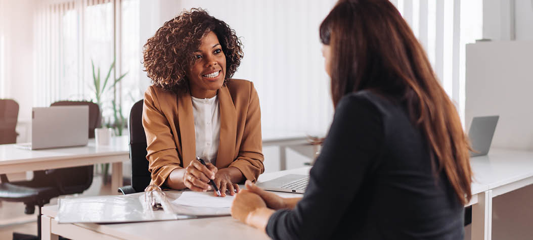 Female financial consultant manager talking with a client at the bank